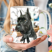  3D tear-effect dog design on a mug. Name-printed schnauzer art mug. The photo shows a close-up of a woman holding a personalized coffee mug